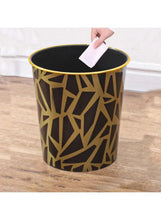 Black trash can with gold geometric pattern and gold-trimmed open top