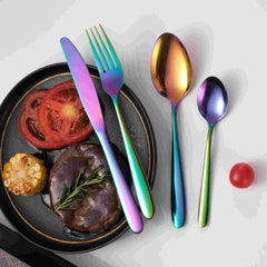 Huitich modern rainbow spoon fork knife set displayed beside a plate with steak, corn, and tomato slices
