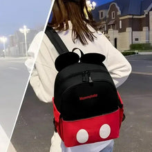 Back view baby backpack with black mouse-ear top and red bottom with white dot accents