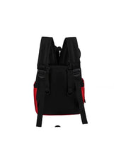 Black baby travel backpack with red side panels, back straps, and adjustable buckles