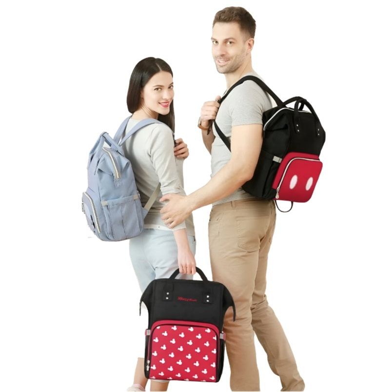 Huitich black and red baby travel bag casual backpack worn by man with woman carrying light blue backpack