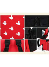 Baby travel backpack detail showing straps, buckles, red panels, and zipper features