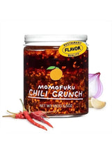 Chili crunch jar with metal lid, dark red chili oil and crunchy garlic pieces