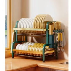 Huitich 2 tier dish rack in green and wood finish holding plates and kitchen utensils on a countertop