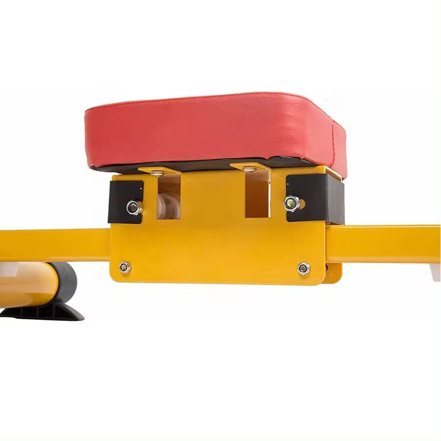 Close-up of red padded seat on yellow multi gym rower for children by Huitich
