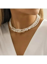 Multi-layer pearl choker necklace with three bead strands and linked heart centerpiece