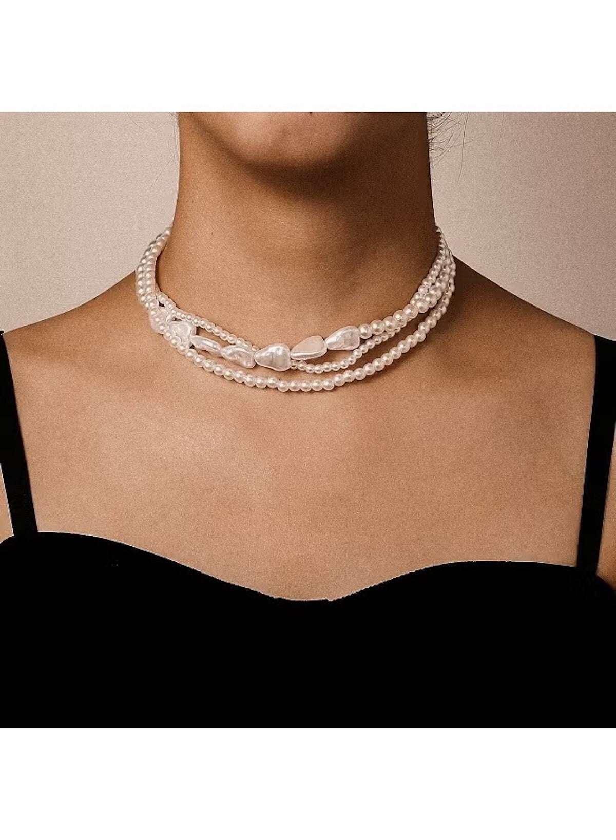 Elegant multi-layer pearl choker necklace featuring various pearl sizes for a stylish look