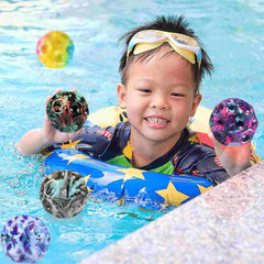 Child playing in pool with Huitich multicolor bouncing ball set featuring vibrant, textured balls
