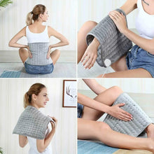 Gray electric heating pad wrapped on a person’s back with white controller
