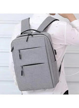 Light grey travel backpack with top handle and front zip pocket