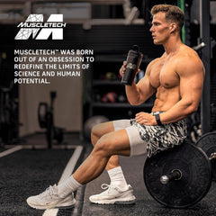 Muscletech advertisement of muscular man in gym holding shaker by barbell promoting whey protein powder UAE