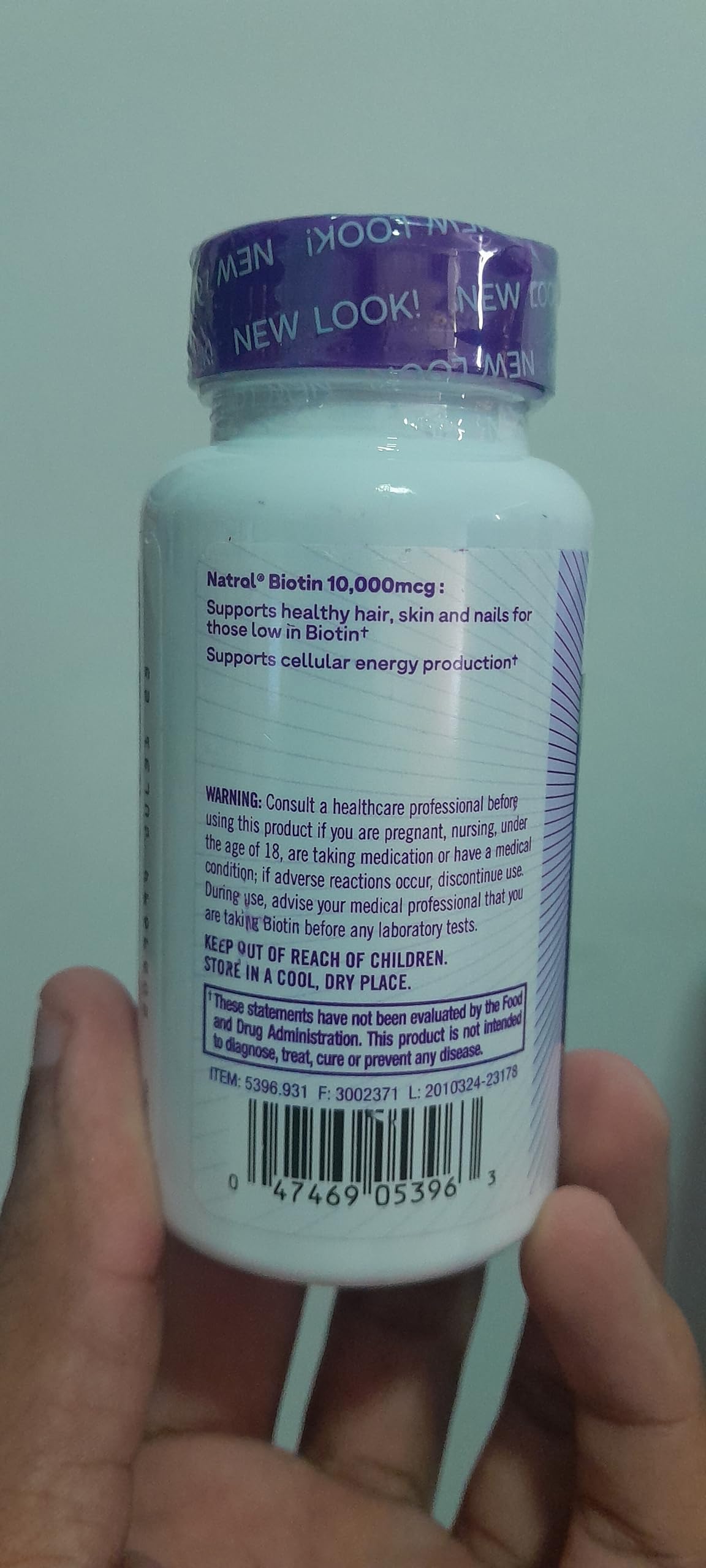 Natrol Biotin 10000 mcg tablets in a white bottle promoting healthy hair, skin, and nails