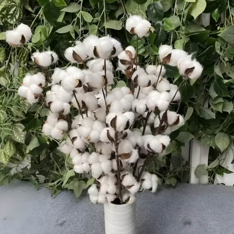 Huitich artificial flowers featuring natural cotton branch decor in a white vase with green leafy background