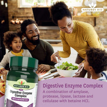 Natures Aid digestive enzyme complex bottle on table while family eats salad