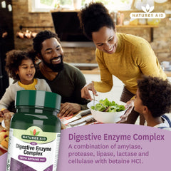 Green Natures Aid bottle of digestive enzyme complex tablets shown with smiling family sharing salad at kitchen table