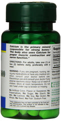 Natures Bounty green pill bottle of high potency calcium supplement UAE with nutrition label visible