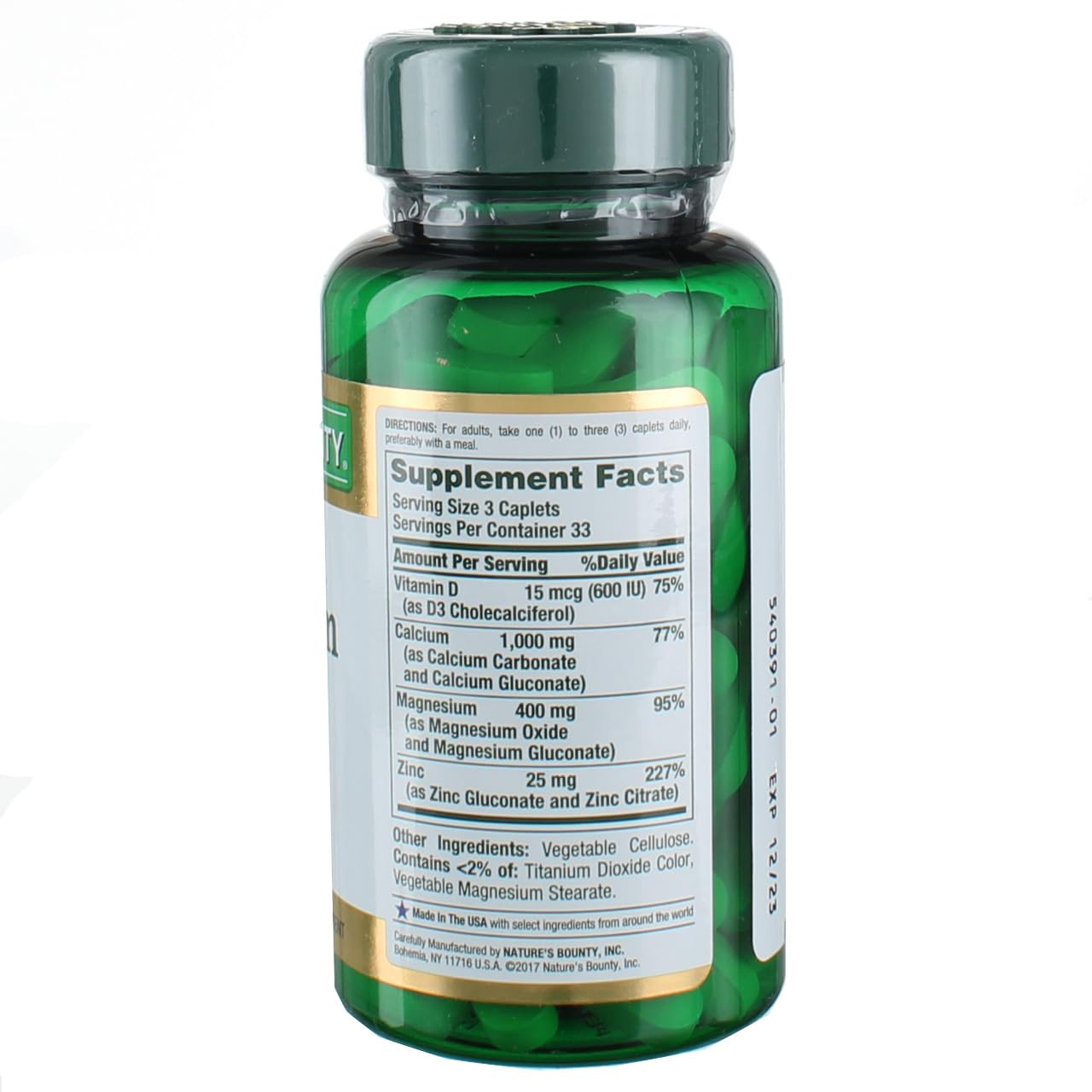 Green Nature's Bounty calcium magnesium zinc 100 caplets bottle showing supplement facts label and visible caplets