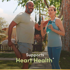Nature's Bounty fish oil 1200mg supplement promoting heart health shown with active middle aged couple stretching outdoors