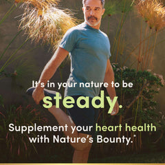 Middle aged man stretching outdoors with text overlay promoting Nature's Bounty fish oil 1200mg for heart health