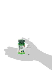 Small green bottle of Nature's Bounty folic acid 400 mcg supplements shown on hand silhouette for scale