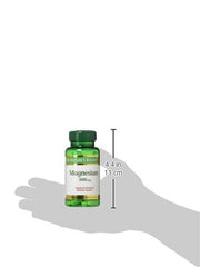 Green bottle of Nature's Bounty magnesium tablets 500 mg resting on hand silhouette with 4.4 in height marker