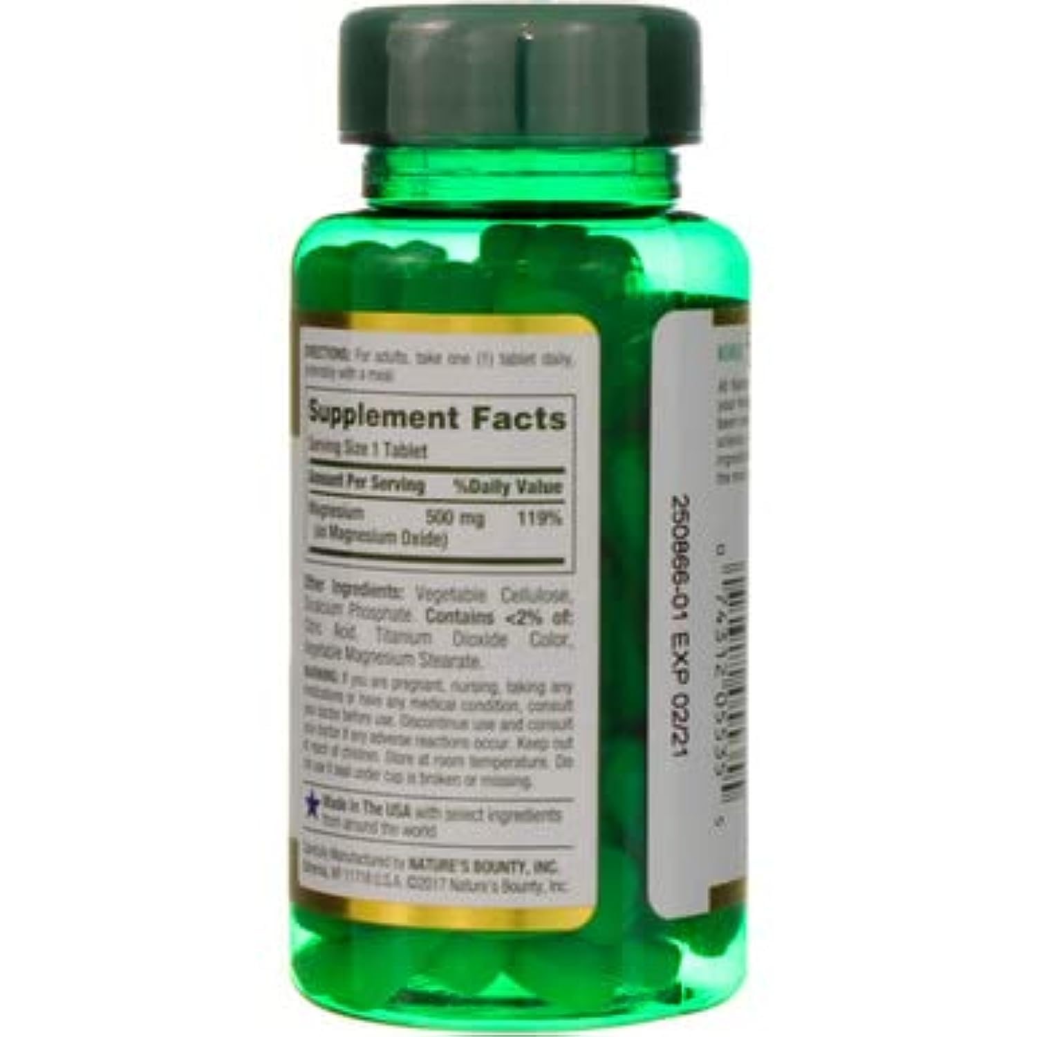 Green bottle of Nature's Bounty magnesium tablets showing supplement facts label and tablets
