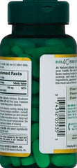Green bottle of Nature's Bounty magnesium tablets with visible green tablets and supplement label