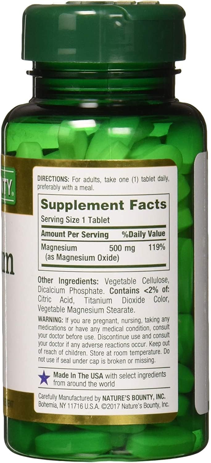 Green Nature's Bounty magnesium tablets bottle showing supplement facts label and white tablets inside