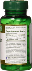 Green Nature's Bounty magnesium tablets bottle showing supplement facts label and white tablets inside