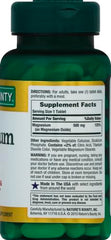 Green Nature's Bounty magnesium tablets bottle showing Supplement Facts label 500 mg and dosage directions