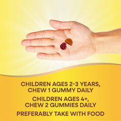 Hand holding two children's multivitamin gummies on yellow background with dosage text for ages 2 to 4 and up