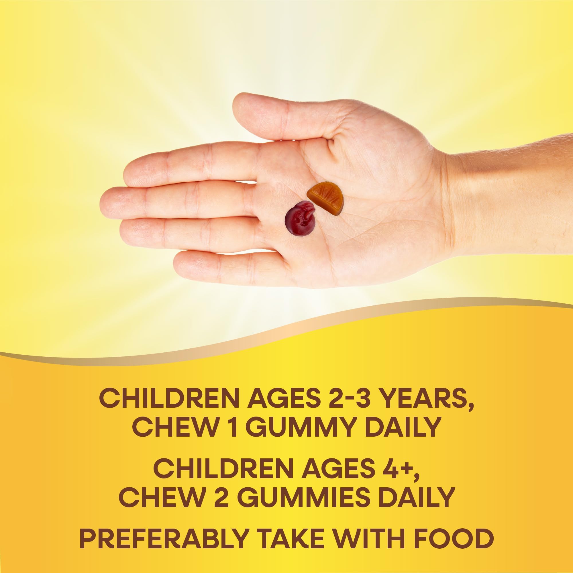 Nature's Way children's multivitamin gummies in an open palm with dosing info for ages two to three and four and up