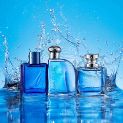 Three blue Nautica fragrance bottles with water splash showcasing Nautica Voyage long lasting scent