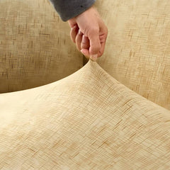 Huitich beige sofa slipcover with textured pattern being stretched on a three seat sofa cover