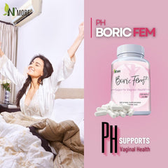 NMore Boric Fem bottle and white suppositories beside smiling woman stretching in bed promoting boric acid vaginal suppositories