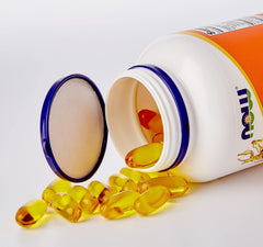Open NOW pill bottle spilling golden softgel capsules Now Foods Super Omega 3-6-9 supplement for daily omega support