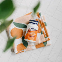 Vitamin D3 supplement bottle and dark cap on patterned blanket