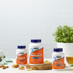 NOW bottles of Omega 3 and CoQ10 with softgel capsules walnuts and tea on counter omega 3 supplements UAE