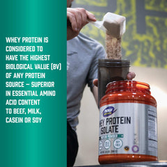 Person scooping NOW whey protein into shaker from orange jar labeled whey protein isolate powder UAE for post workout