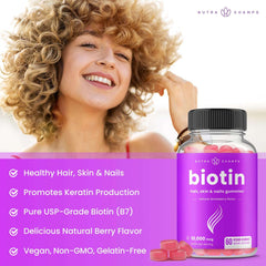 Smiling woman with curly blonde hair beside NutraChamps biotin gummies for hair growth bottle and benefits list