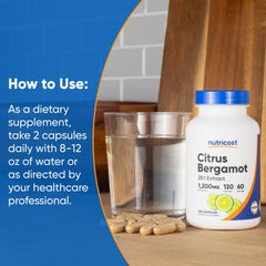 Nutricost Citrus Bergamot capsules 1200mg bottle with directions and capsules on a wooden surface