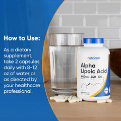 Nutricost alpha lipoic acid supplement UAE bottle with capsules and glass of water on counter