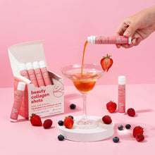 Beauty collagen shots box, pink vials, and poured liquid glass with berries