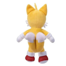 Yellow plush character back view with spiky ears, white gloves, and red shoes.