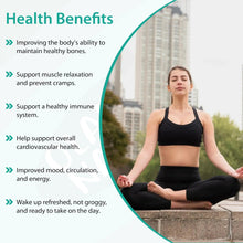 Woman sitting in a yoga pose, wearing black athletic workout clothing