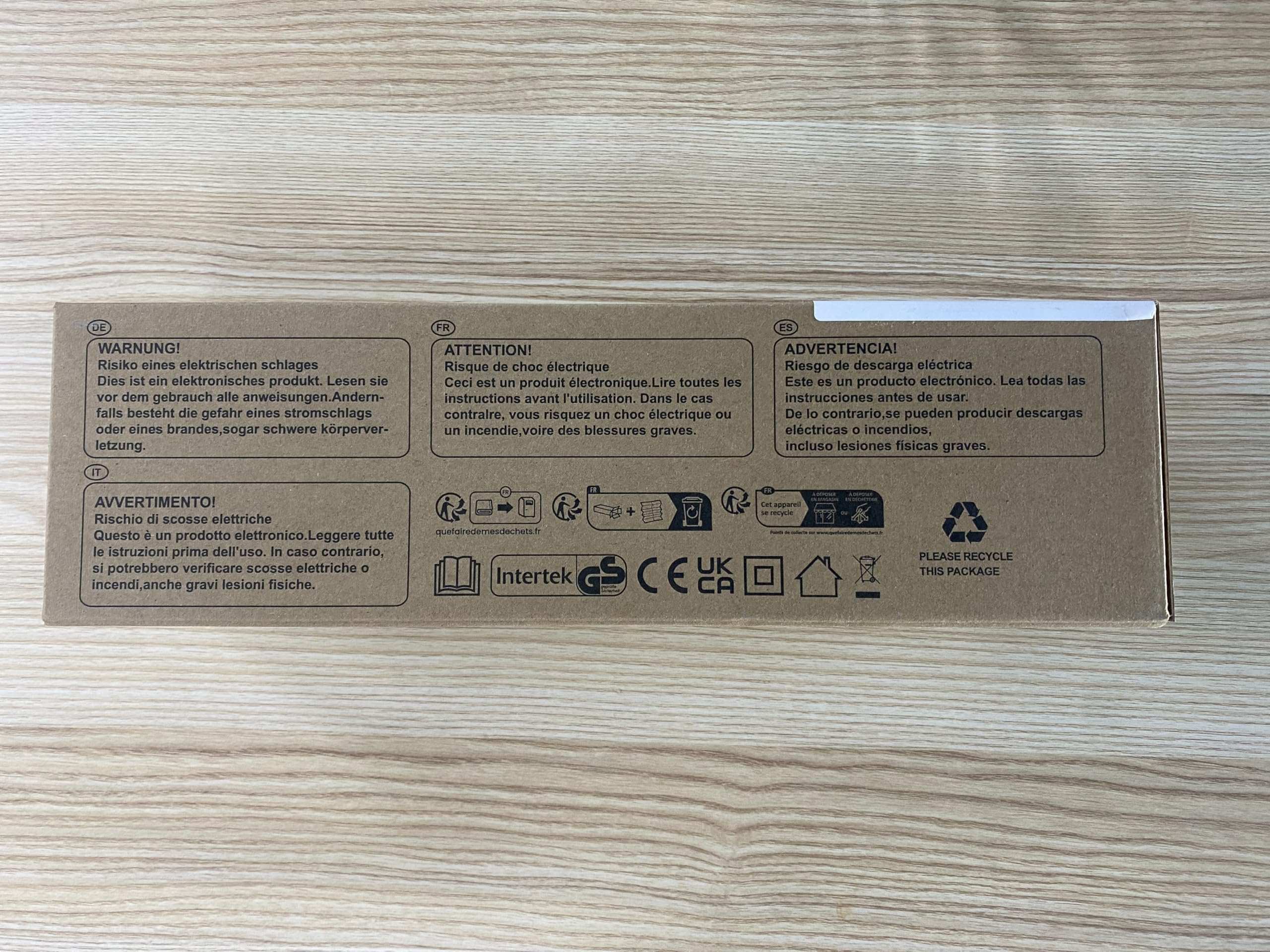 VIBOOS electric heating pad for back pain in cardboard retail box showing warning labels and icons on wood