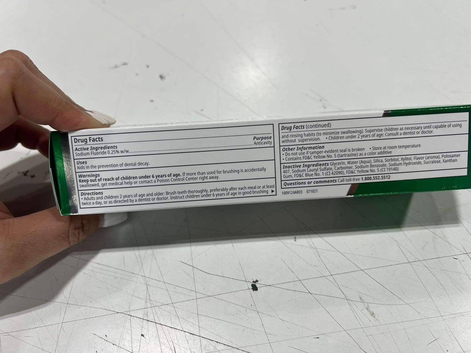 opalescence whitening toothpaste box held showing Drug Facts panel and active ingredient information