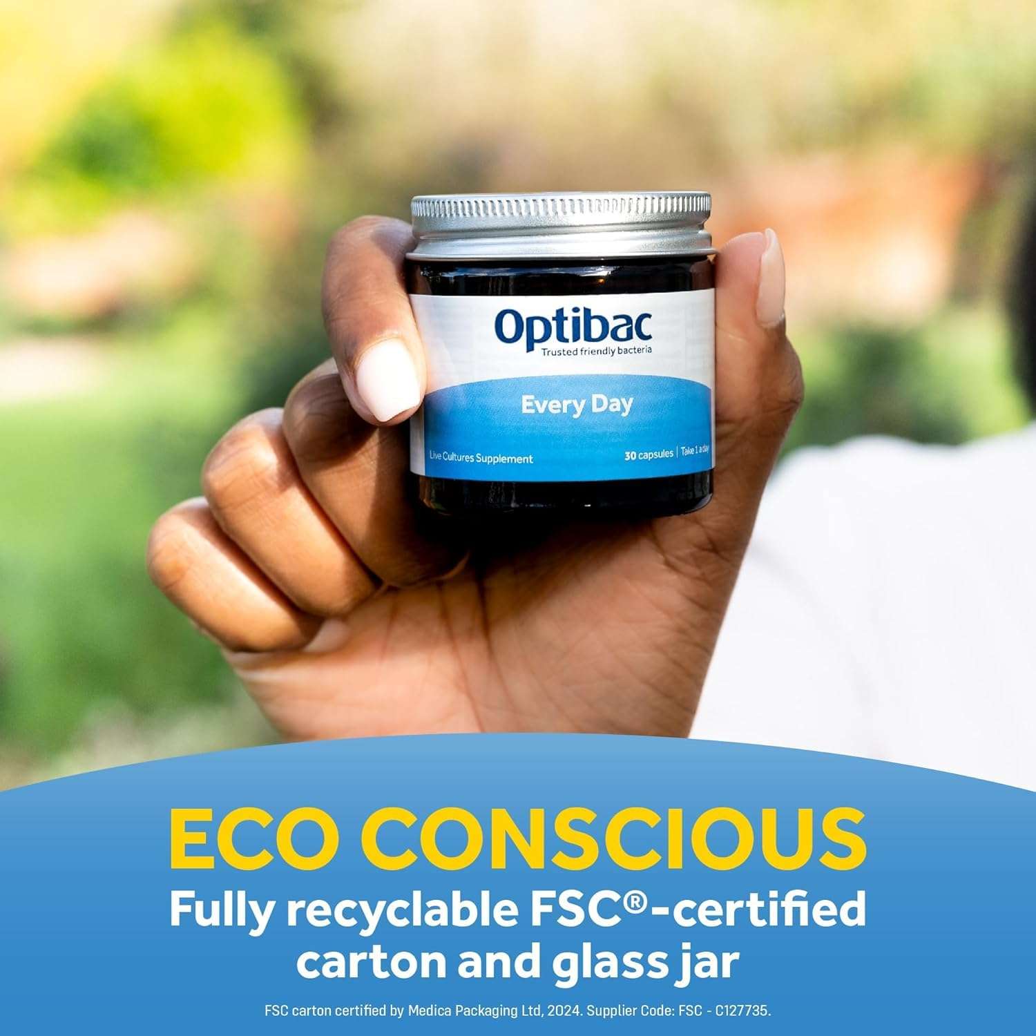 OptiBac Every Day probiotic jar held in hand outdoors with eco conscious label daily probiotics capsules UAE