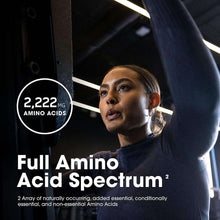 Athlete holding an Optimum Nutrition amino acid tablets bottle, “Full Amino Acid Spectrum”
