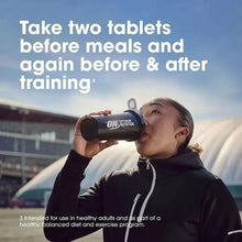 Athlete drinking from an Optimum Nutrition amino acid tablets bottle; take two tablets